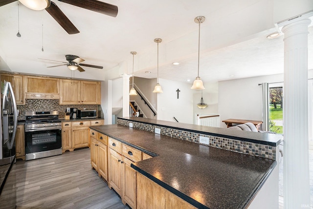 kitchen with a ceiling fan, decorative backsplash, appliances with stainless steel finishes, and dark countertops
