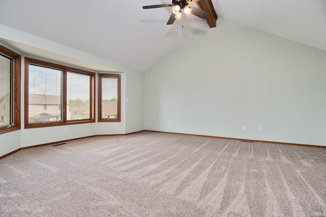 carpeted empty room with baseboards, lofted ceiling with beams, a ceiling fan, and visible vents
