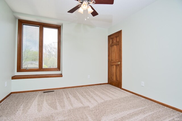 unfurnished room with baseboards, a ceiling fan, carpet flooring, and visible vents
