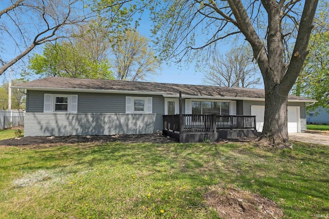 ranch-style home featuring a garage, a front lawn, fence, and driveway