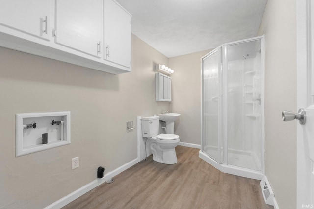 bathroom with toilet, baseboards, a shower stall, wood finished floors, and visible vents