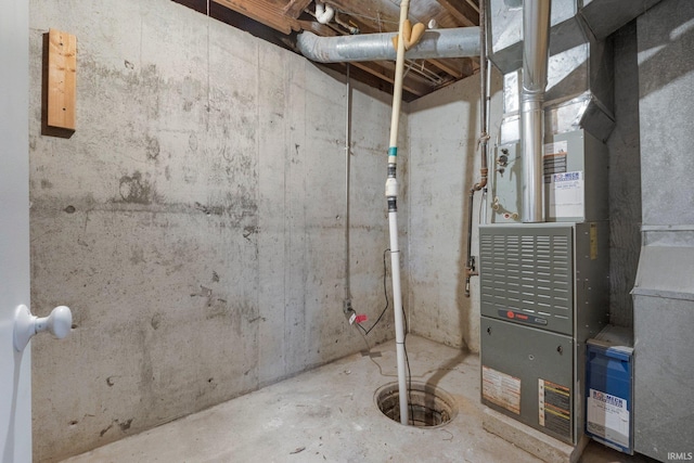 utility room featuring heating unit