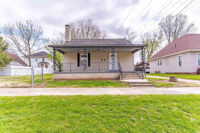bungalow-style house with a porch, a chimney, a front yard, brick siding, and fence