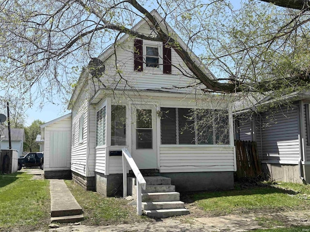 view of front facade featuring entry steps and a sunroom