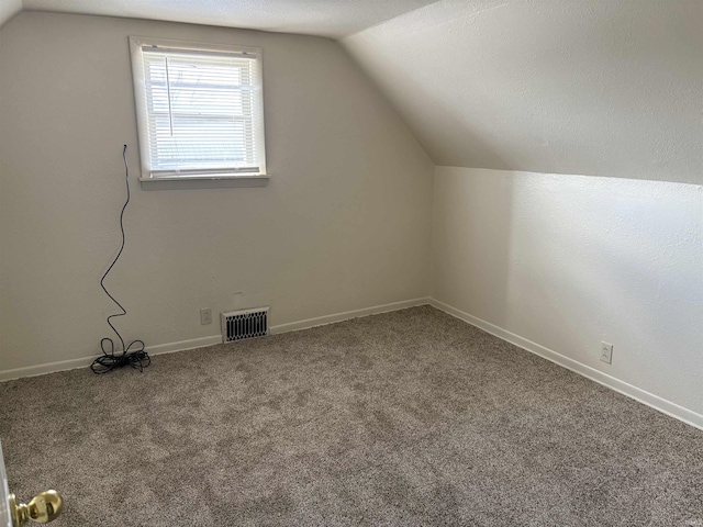 bonus room featuring baseboards, visible vents, carpet, and lofted ceiling