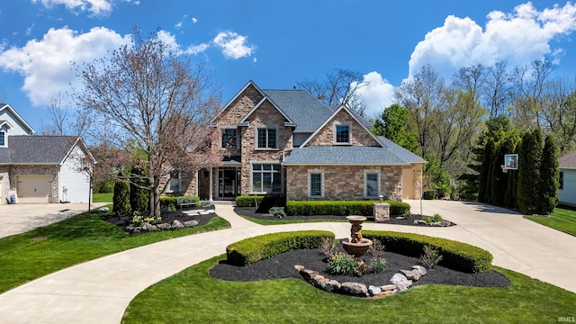 view of front facade with curved driveway, a front yard, and stone siding