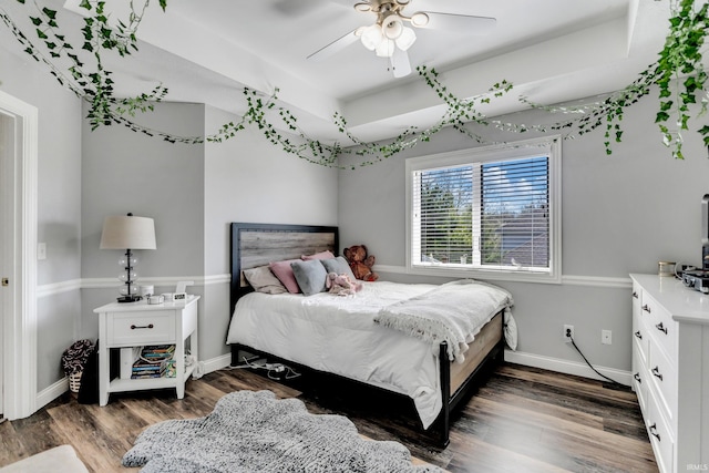 bedroom featuring a ceiling fan, baseboards, and wood finished floors
