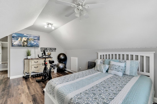 bedroom featuring baseboards, ceiling fan, wood finished floors, and vaulted ceiling