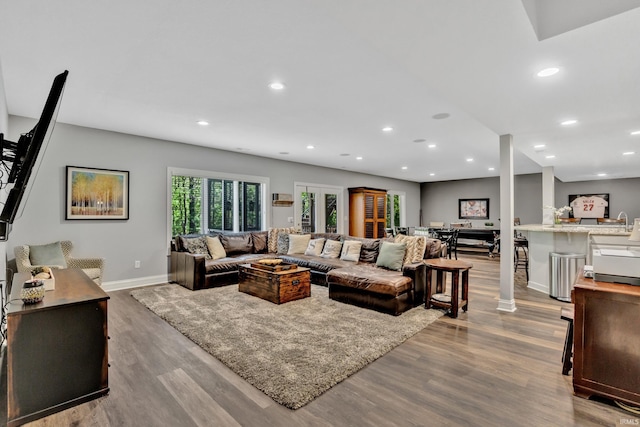 living room with baseboards, recessed lighting, and wood finished floors