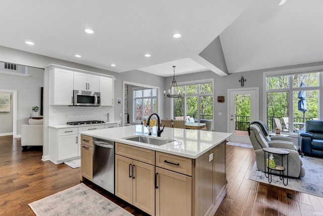 kitchen featuring light countertops, stainless steel appliances, visible vents, and a sink
