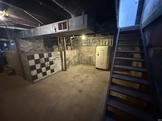 unfinished basement featuring visible vents and water heater