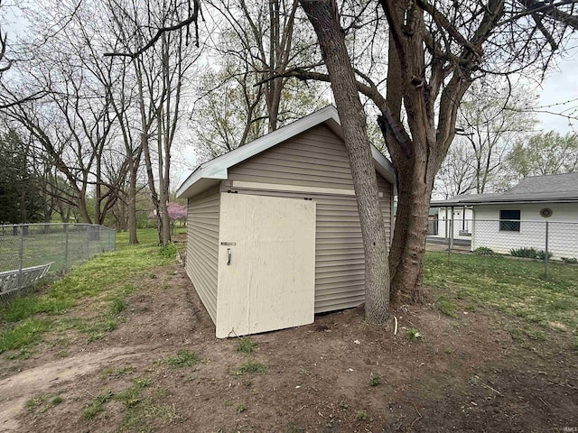 view of outbuilding with fence and an outbuilding