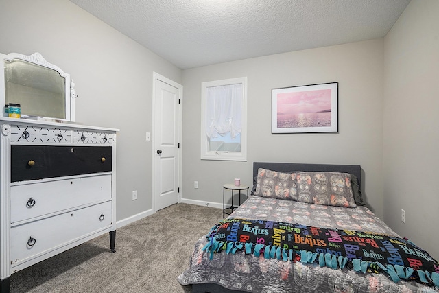 carpeted bedroom with baseboards and a textured ceiling