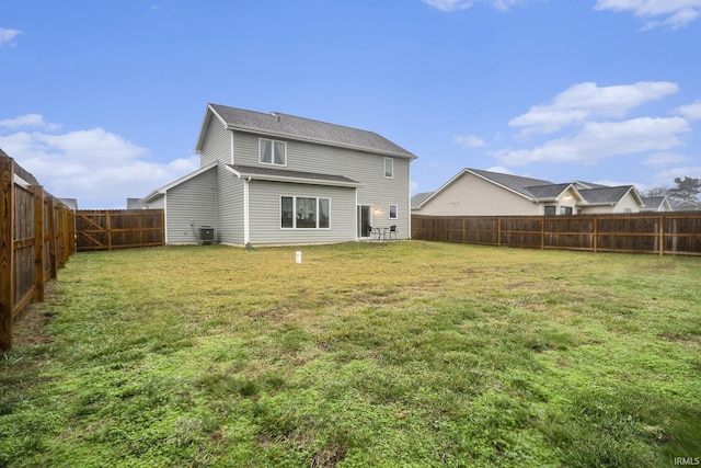 back of property featuring a lawn and a fenced backyard