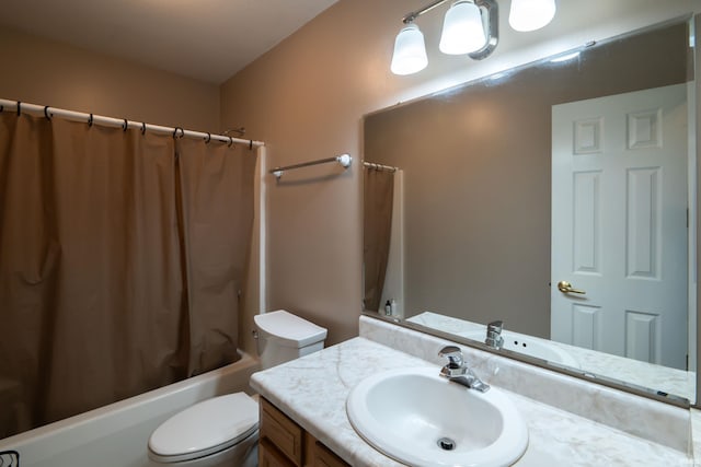 bathroom with vanity, toilet, and shower / tub combo
