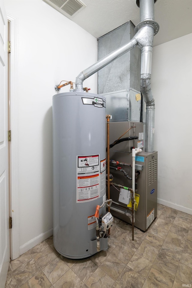 utilities with gas water heater and visible vents