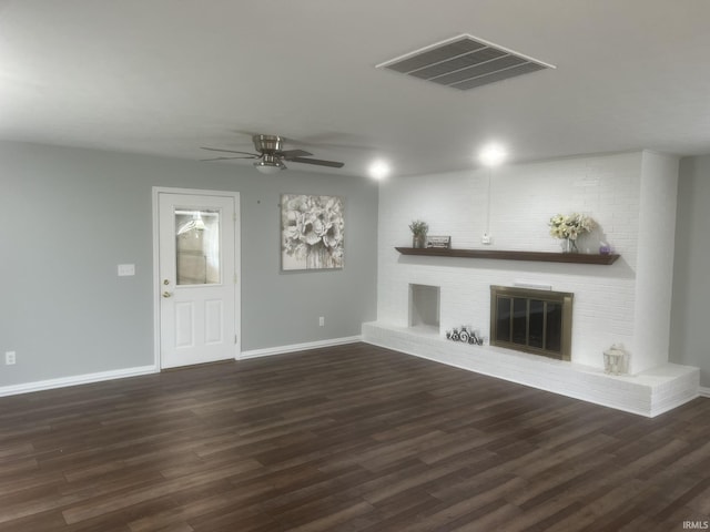 unfurnished living room featuring a ceiling fan, visible vents, a fireplace, wood finished floors, and baseboards