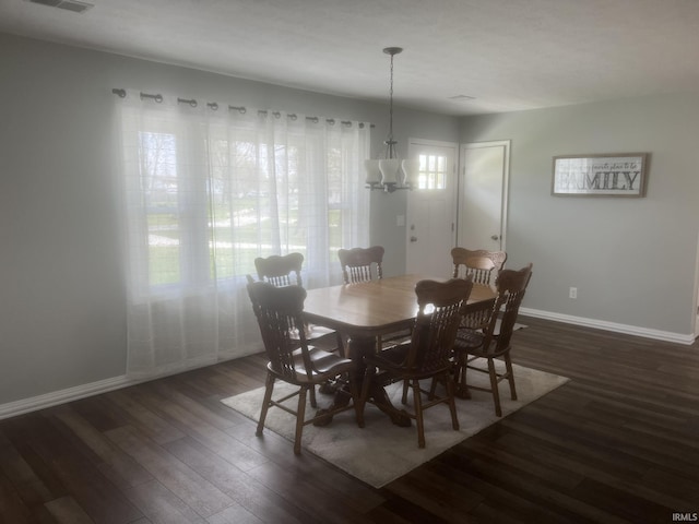 dining room featuring baseboards, a chandelier, and dark wood-type flooring