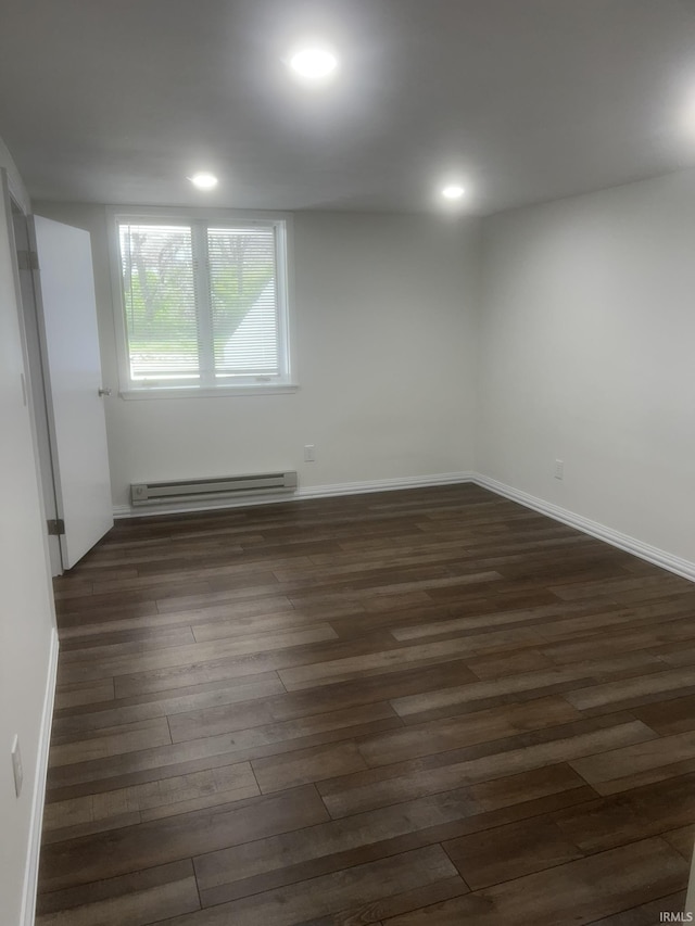 unfurnished room with recessed lighting, dark wood-style floors, and a baseboard radiator
