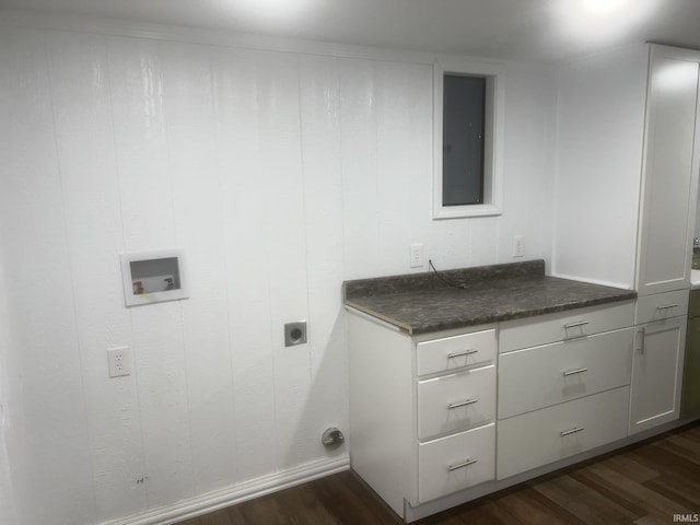 washroom featuring hookup for an electric dryer, dark wood-style flooring, cabinet space, baseboards, and hookup for a washing machine