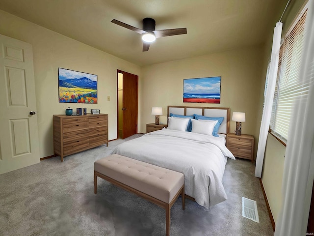 bedroom with carpet floors, ceiling fan, baseboards, and visible vents