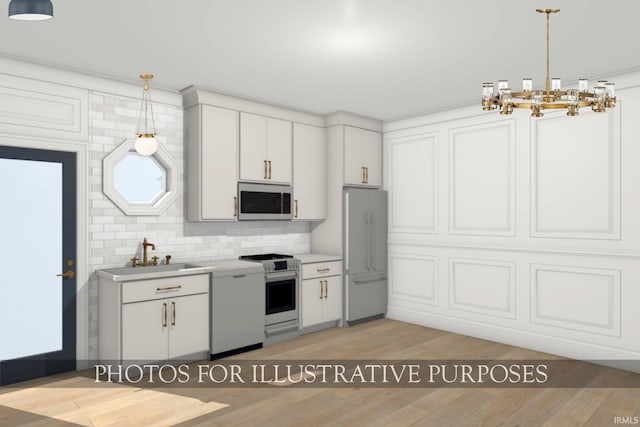 624B N Notre Dame Ave Unit B, South Bend, IN 46617 - kitchen featuring light countertops, white cabinetry, a sink, a notable chandelier, and stainless steel appliances