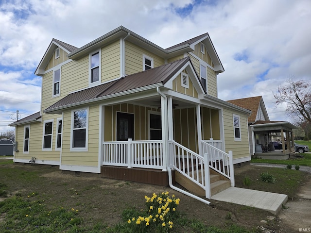 view of property exterior featuring a standing seam roof, a porch, and metal roof