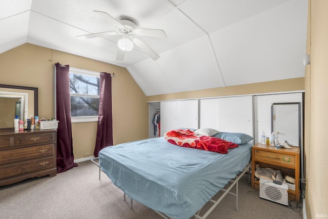 bedroom featuring a ceiling fan, carpet flooring, and lofted ceiling