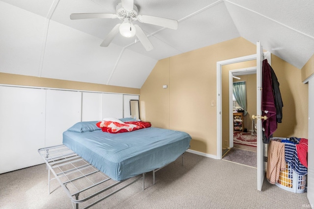 carpeted bedroom with a ceiling fan and lofted ceiling