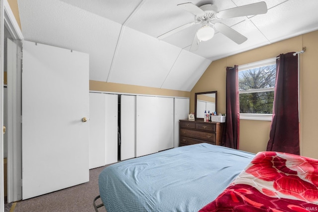bedroom featuring carpet floors, ceiling fan, lofted ceiling, and a closet