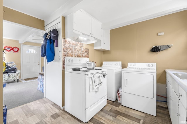laundry room featuring independent washer and dryer, laundry area, a sink, and light wood-style floors