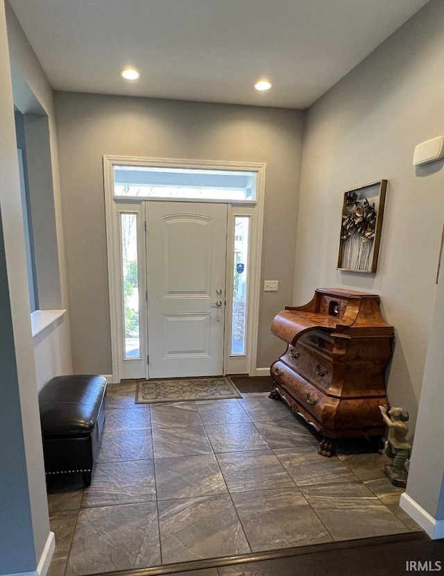 foyer with baseboards and recessed lighting