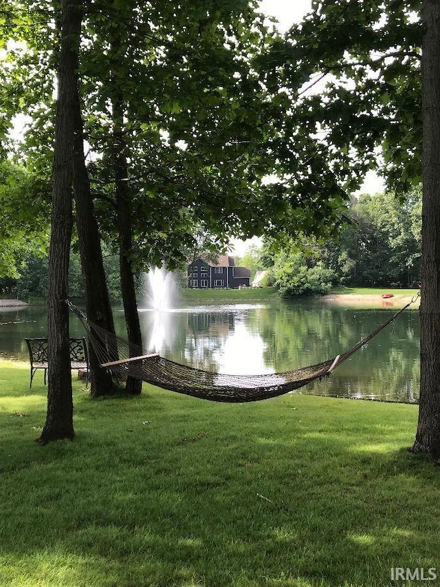 view of community with a water view and a yard