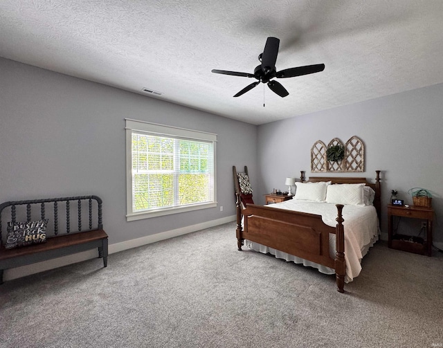 bedroom with baseboards, a textured ceiling, carpet, and a ceiling fan