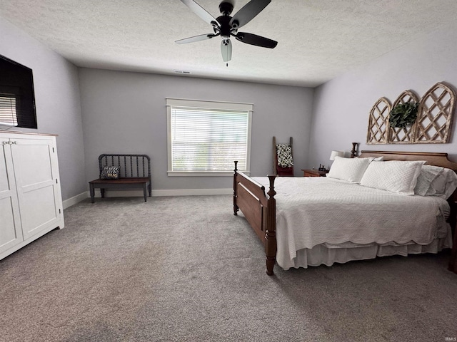 bedroom with carpet floors, a ceiling fan, a textured ceiling, and baseboards