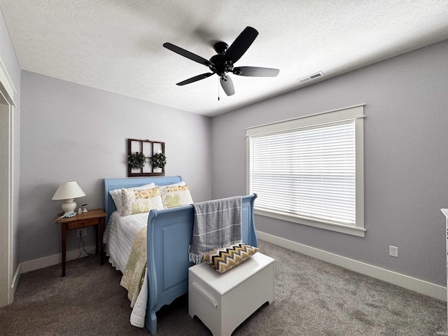 carpeted bedroom with baseboards, a ceiling fan, and visible vents