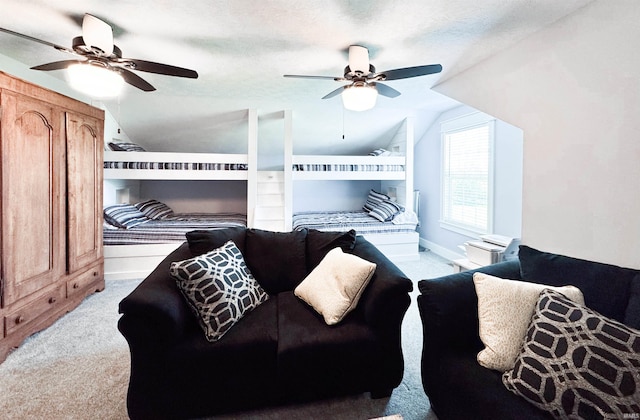 bedroom with ceiling fan, lofted ceiling, and light colored carpet