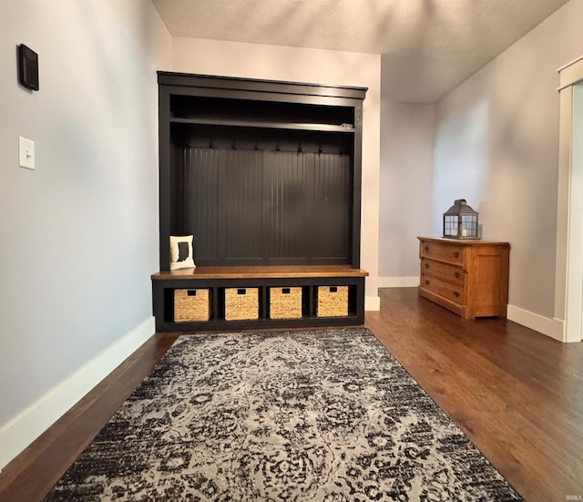 mudroom with baseboards and wood finished floors