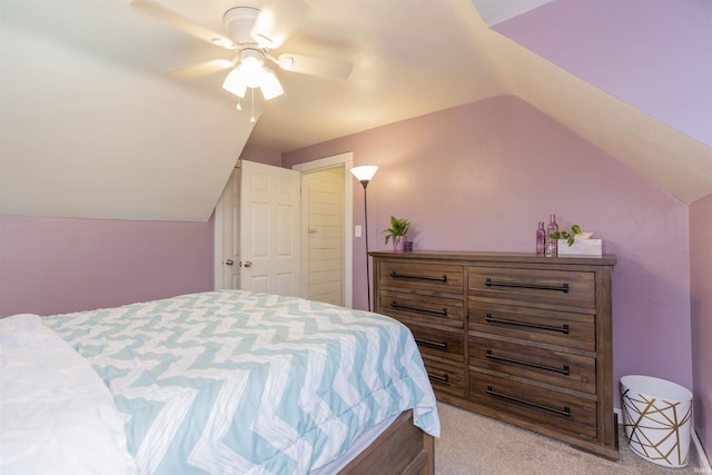 bedroom featuring ceiling fan, vaulted ceiling, and light carpet