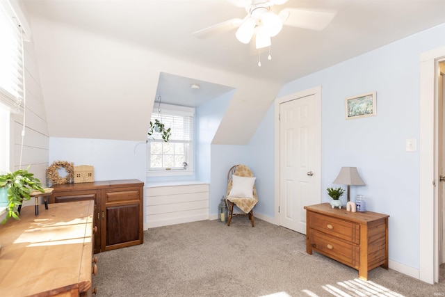 interior space featuring ceiling fan and vaulted ceiling