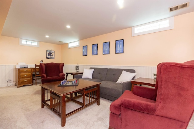 carpeted living room with wainscoting, recessed lighting, and visible vents