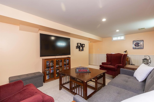 living area featuring recessed lighting, a wainscoted wall, visible vents, and light carpet
