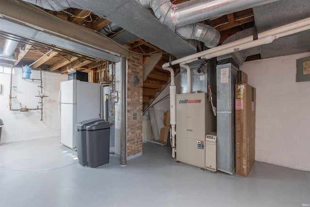 unfinished below grade area featuring freestanding refrigerator