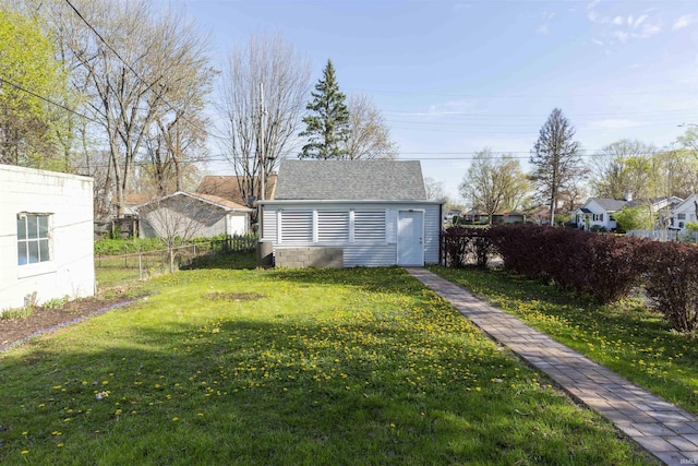 view of yard with fence and an outdoor structure