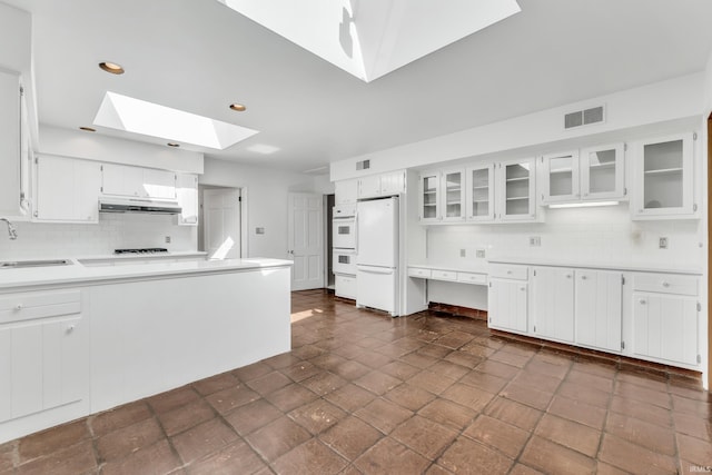 8818 Fortuna Way, Fort Wayne, IN 46815 - kitchen with decorative backsplash, visible vents, a skylight, under cabinet range hood, and white appliances