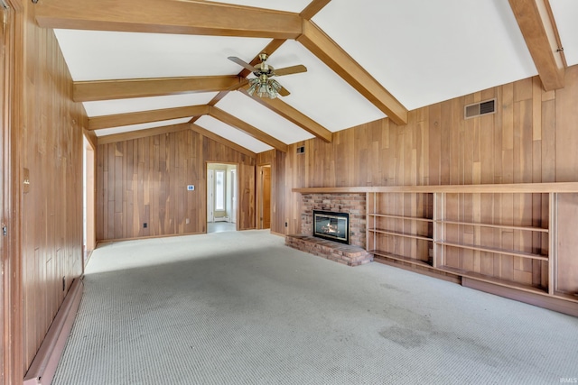 8818 Fortuna Way, Fort Wayne, IN 46815 - unfurnished living room with wooden walls, a fireplace, a ceiling fan, vaulted ceiling with beams, and visible vents
