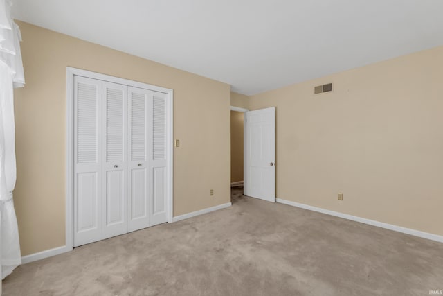 8818 Fortuna Way, Fort Wayne, IN 46815 - unfurnished bedroom with light colored carpet, baseboards, visible vents, and a closet