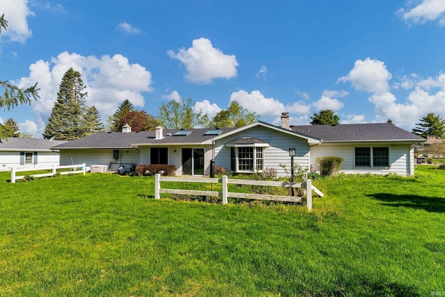 8818 Fortuna Way, Fort Wayne, IN 46815 - back of property with roof mounted solar panels, fence, a yard, and a chimney