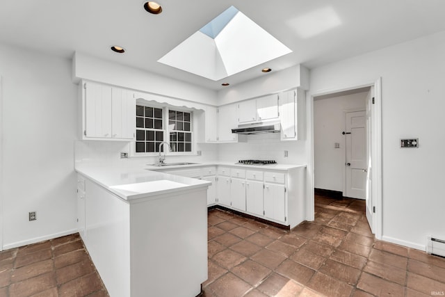 8818 Fortuna Way, Fort Wayne, IN 46815 - kitchen featuring a sink, a skylight, backsplash, and under cabinet range hood