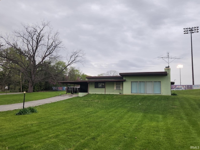 2203 S Valley Ave, Marion, IN 46953 - ranch-style home featuring concrete driveway, a carport, a chimney, and a front lawn